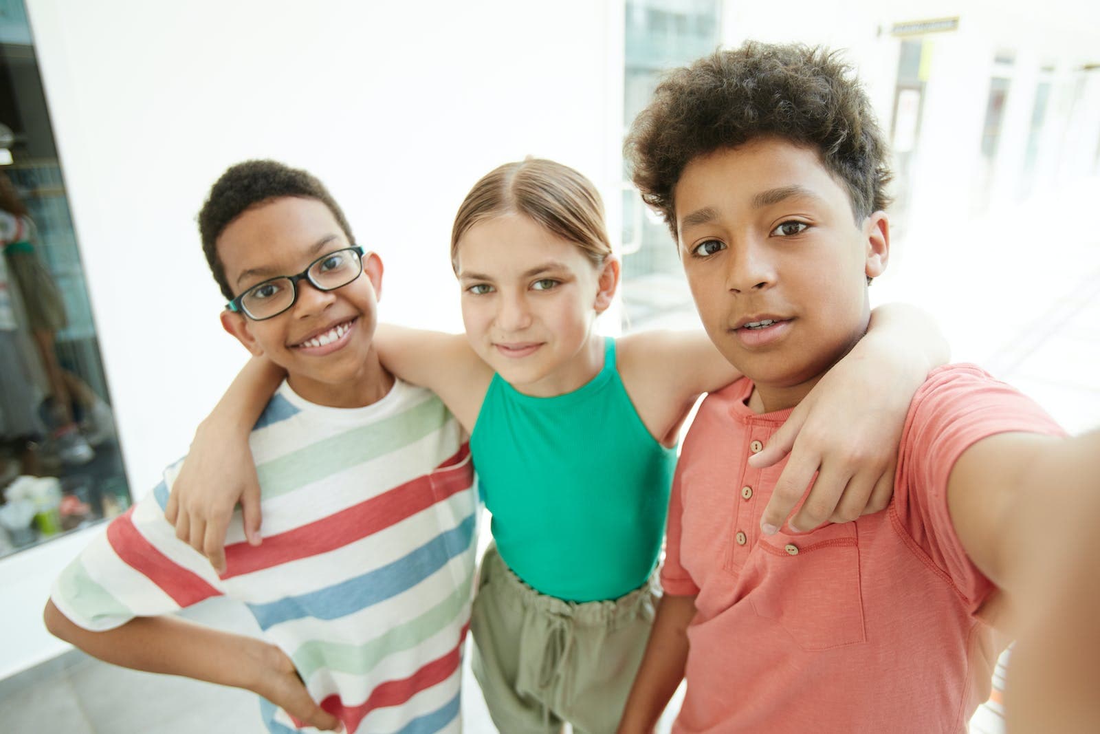 Boy in Blue and White Striped Tank Top Beside Boy in Pink Polo Shirt