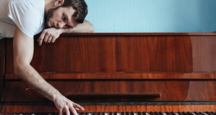 Man die de piano speelt vanaf de bovenkant van de piano