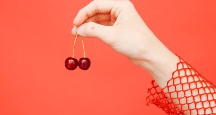 Close-up of a Hand Holding Cherries
