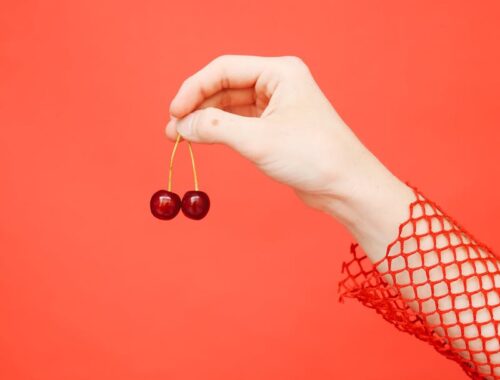 Close-up of a Hand Holding Cherries