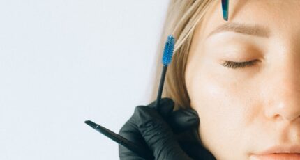 Woman in Black Leather Jacket Wearing Black Headphones